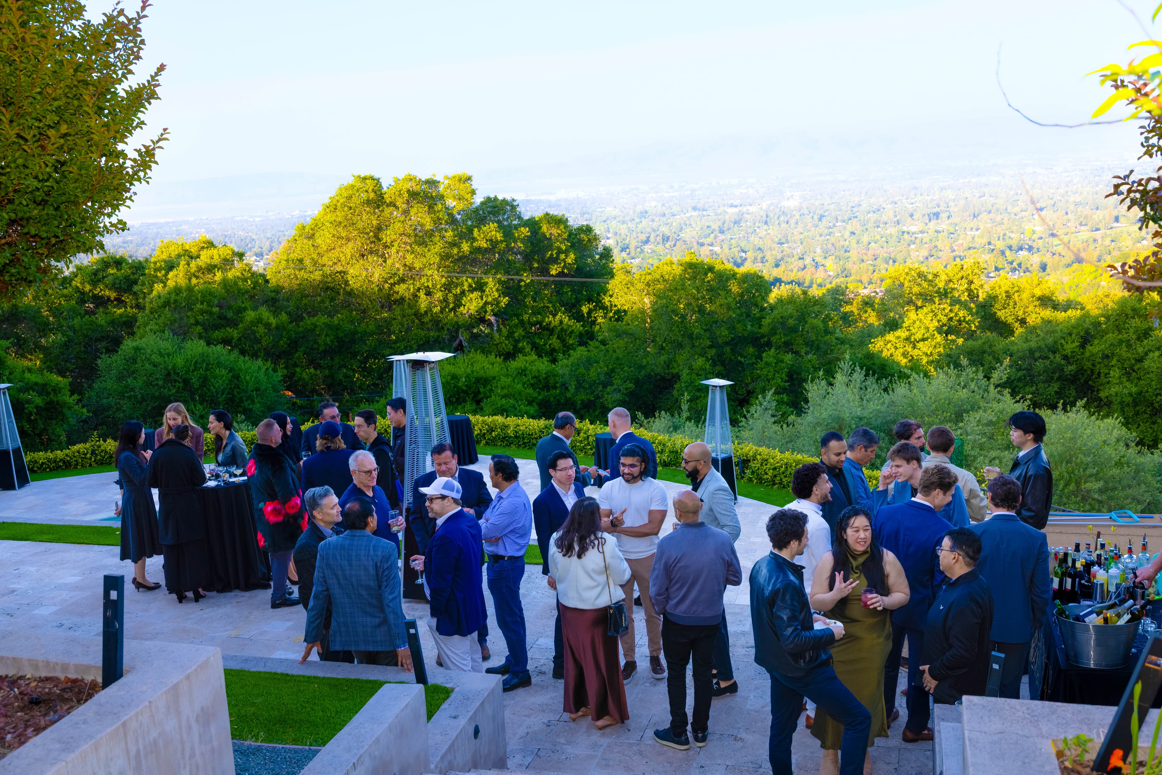 Founders and investors networking on an outdoor terrace