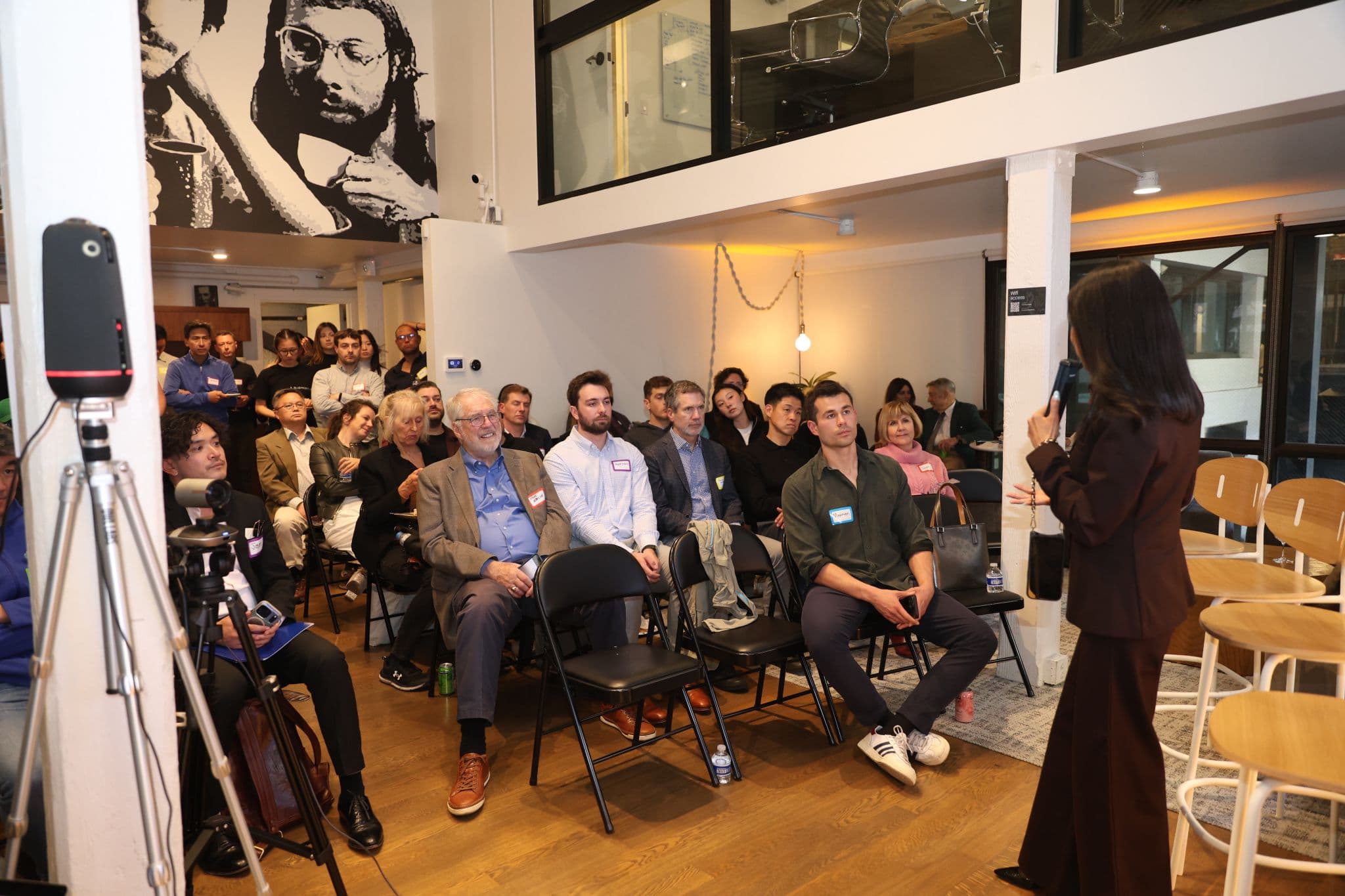 Speaker presenting to an engaged audience at a SFPLAYGROUND pitch event